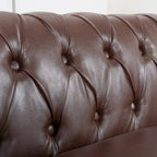 Canapé Chesterfield 3 places en similicuir noir/marron/blanc/orange avec accoudoirs roulés, capitonnage et clous décoratifs