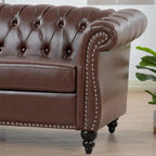 Canapé Chesterfield 3 places en similicuir noir/marron/blanc/orange avec accoudoirs roulés, capitonnage et clous décoratifs